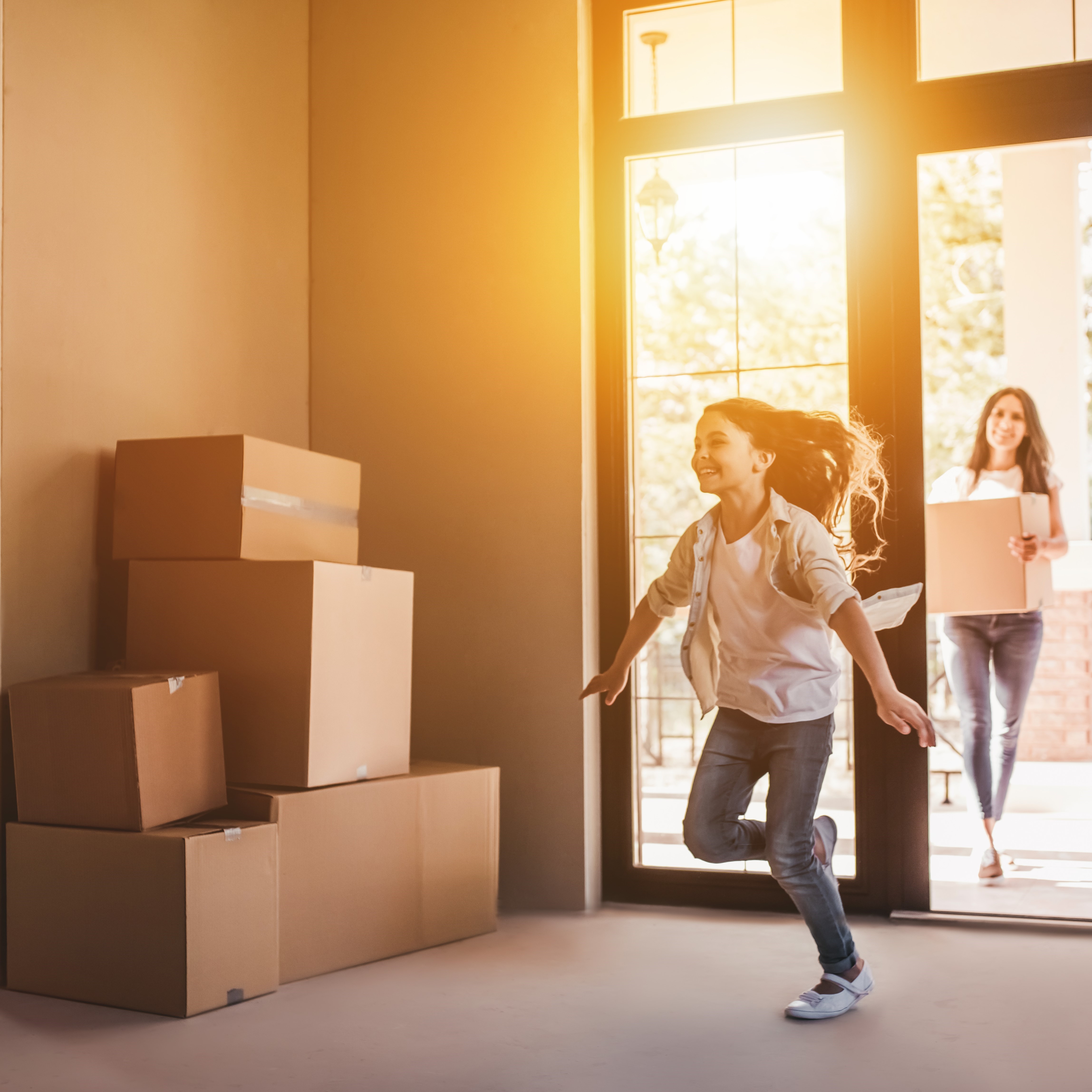 Young girl running through door of her new house.